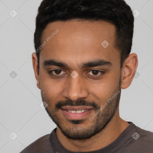Joyful latino young-adult male with short  black hair and brown eyes