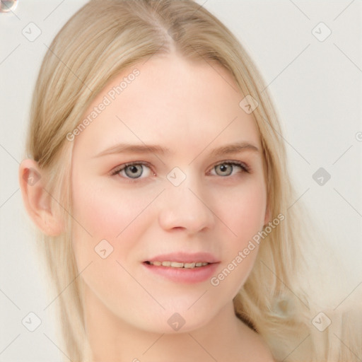 Joyful white young-adult female with long  blond hair and blue eyes