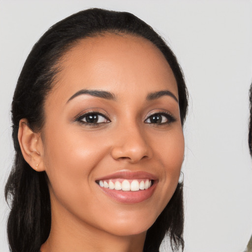 Joyful latino young-adult female with long  brown hair and brown eyes