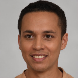 Joyful latino young-adult male with short  brown hair and brown eyes