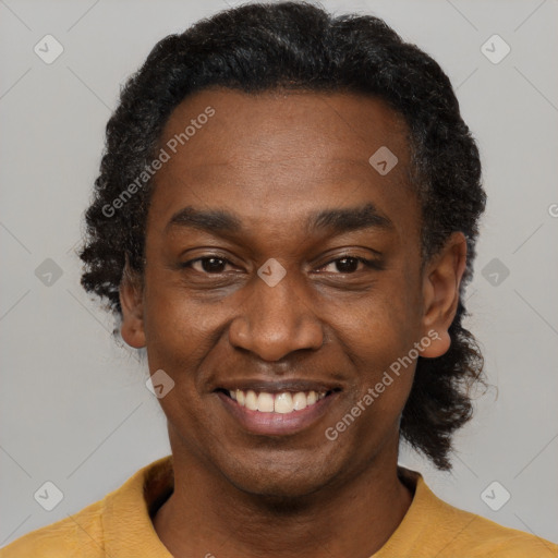 Joyful latino adult male with short  black hair and brown eyes