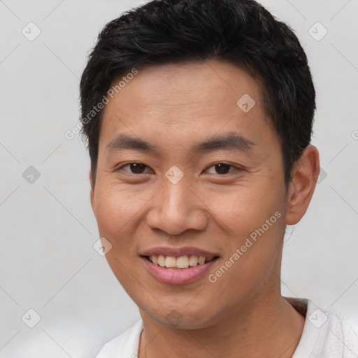 Joyful asian young-adult male with short  brown hair and brown eyes