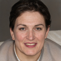 Joyful white adult female with short  brown hair and brown eyes