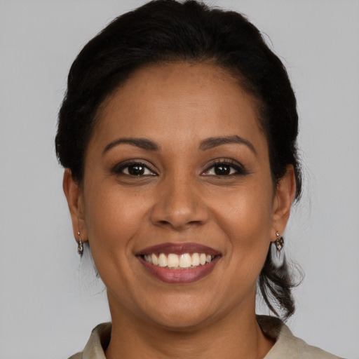 Joyful latino young-adult female with medium  brown hair and brown eyes