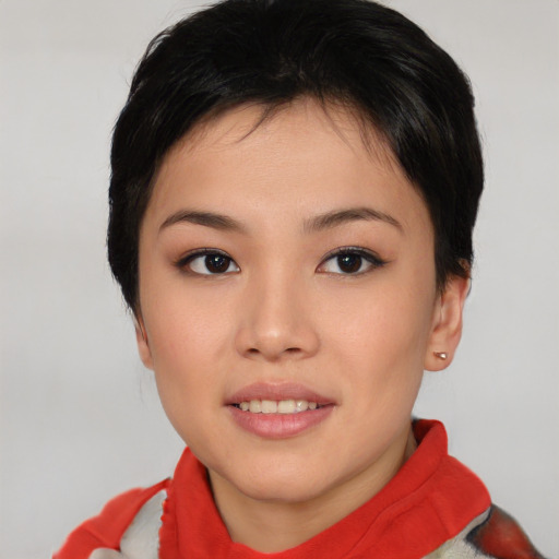 Joyful asian young-adult female with short  black hair and brown eyes