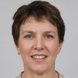 Joyful white adult female with short  brown hair and grey eyes