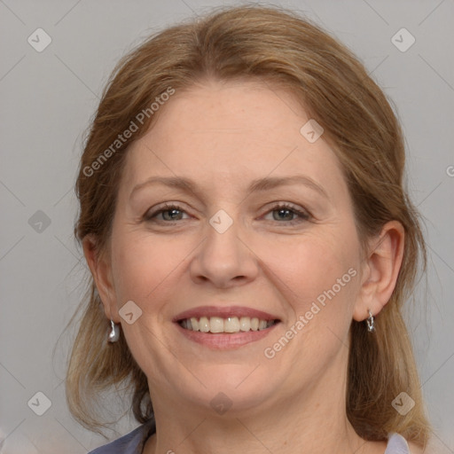 Joyful white adult female with medium  brown hair and blue eyes