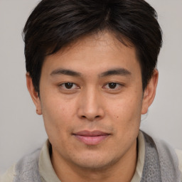 Joyful asian young-adult male with short  brown hair and brown eyes