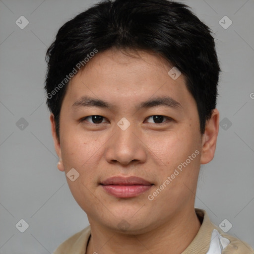 Joyful asian young-adult male with short  brown hair and brown eyes