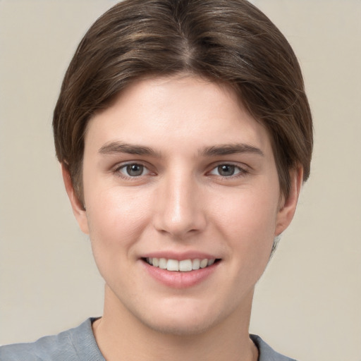 Joyful white young-adult female with short  brown hair and grey eyes