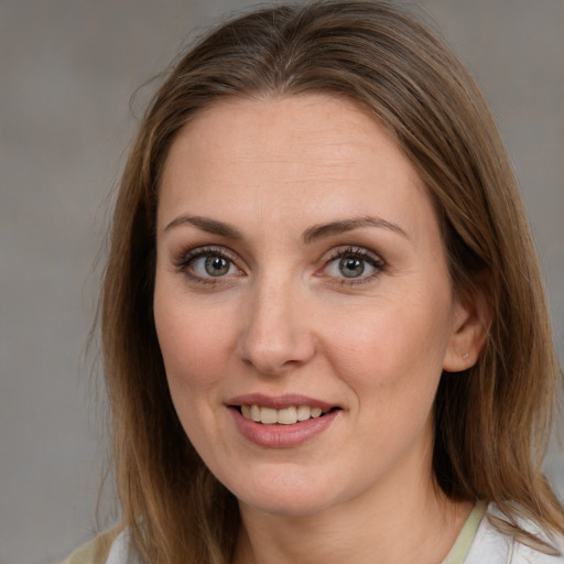 Joyful white young-adult female with medium  brown hair and blue eyes