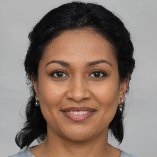 Joyful black young-adult female with medium  brown hair and brown eyes