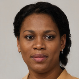 Joyful black adult female with short  black hair and brown eyes