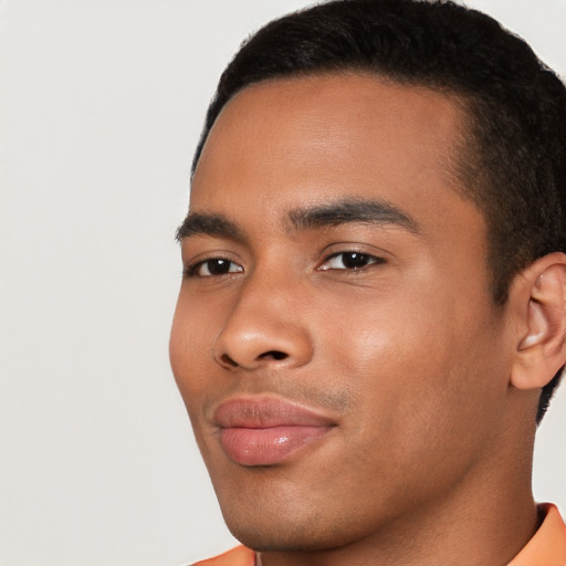 Joyful latino young-adult male with short  brown hair and brown eyes