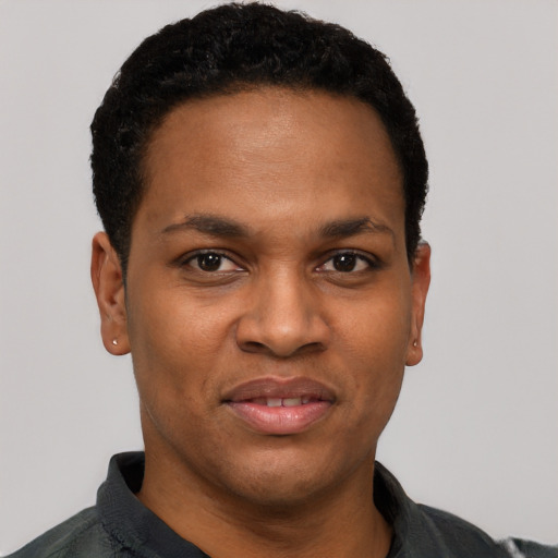 Joyful black young-adult male with short  black hair and brown eyes
