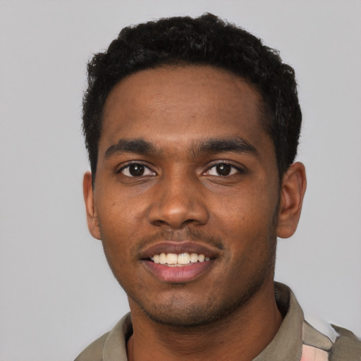 Joyful black young-adult male with short  black hair and brown eyes