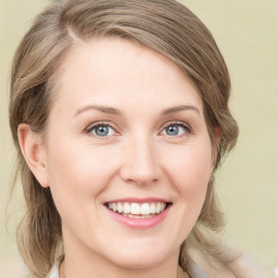 Joyful white young-adult female with medium  brown hair and green eyes