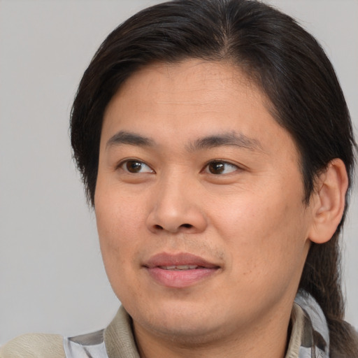 Joyful white young-adult male with medium  brown hair and brown eyes