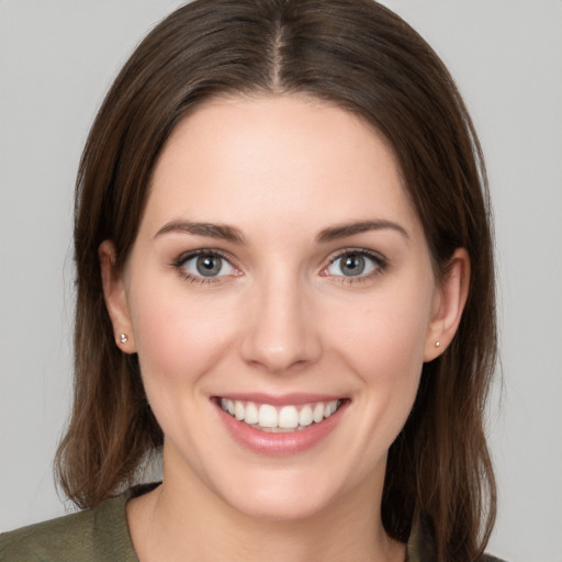 Joyful white young-adult female with long  brown hair and grey eyes