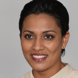 Joyful black young-adult female with short  brown hair and brown eyes