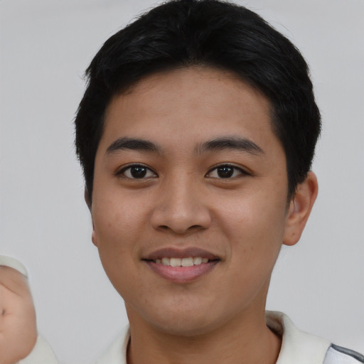 Joyful asian young-adult male with short  black hair and brown eyes