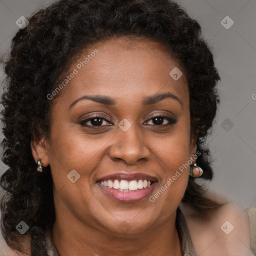 Joyful black young-adult female with long  brown hair and brown eyes