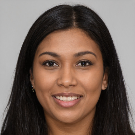 Joyful latino young-adult female with long  black hair and brown eyes