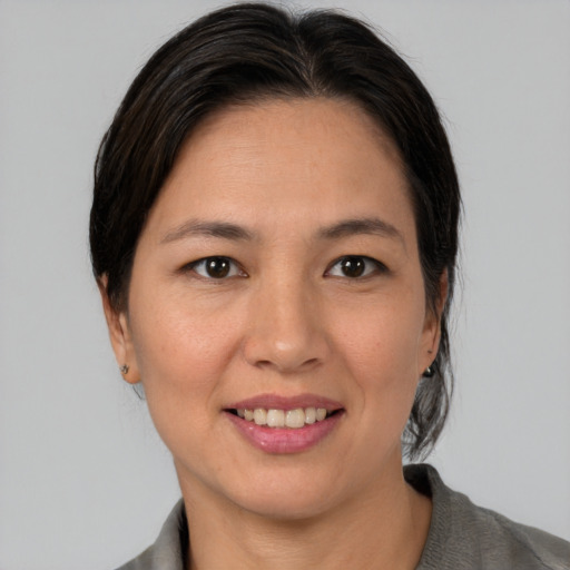 Joyful white young-adult female with medium  brown hair and brown eyes