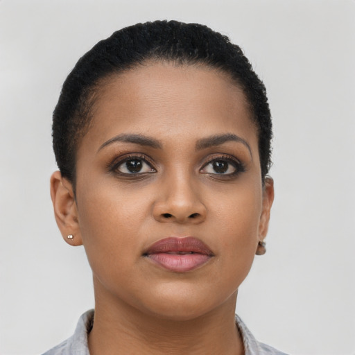 Joyful black young-adult female with short  brown hair and brown eyes