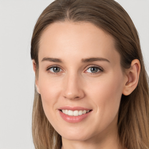 Joyful white young-adult female with long  brown hair and grey eyes