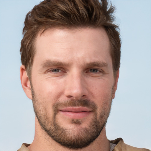 Joyful white adult male with short  brown hair and grey eyes