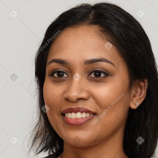 Joyful latino young-adult female with long  brown hair and brown eyes