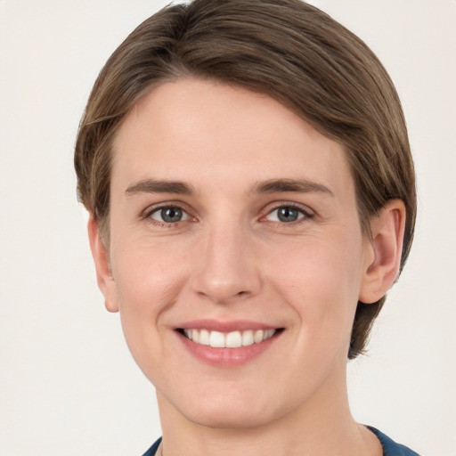 Joyful white young-adult female with short  brown hair and grey eyes