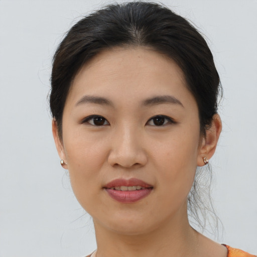 Joyful asian young-adult female with medium  brown hair and brown eyes