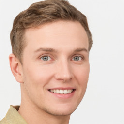 Joyful white young-adult male with short  brown hair and grey eyes