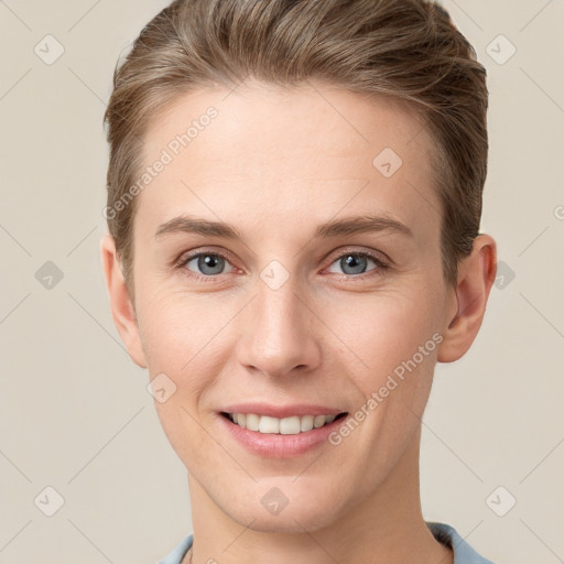 Joyful white young-adult female with short  brown hair and grey eyes