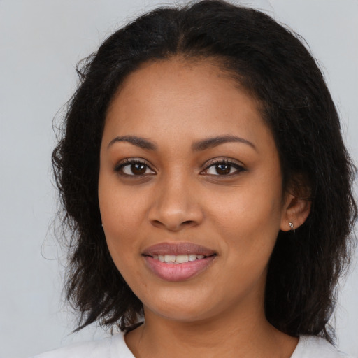 Joyful latino young-adult female with medium  brown hair and brown eyes