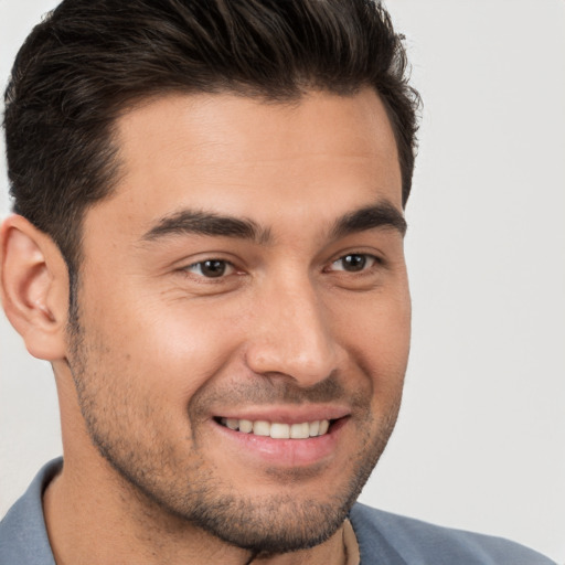 Joyful white young-adult male with short  brown hair and brown eyes