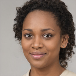 Joyful black young-adult female with long  brown hair and brown eyes