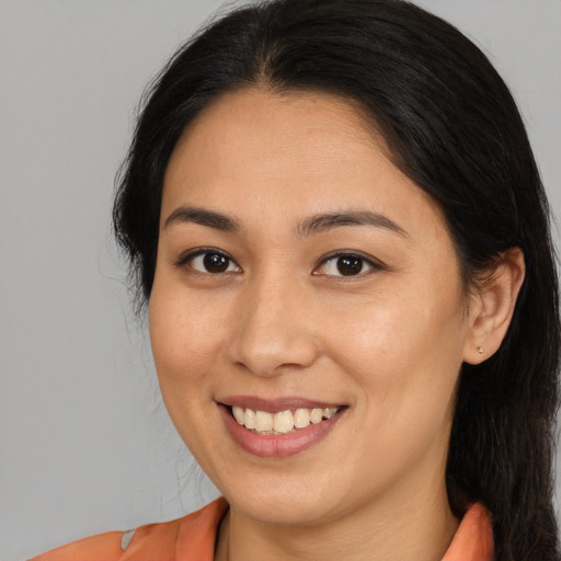 Joyful asian young-adult female with long  brown hair and brown eyes