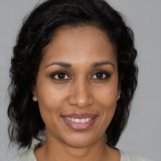 Joyful black young-adult female with medium  brown hair and brown eyes