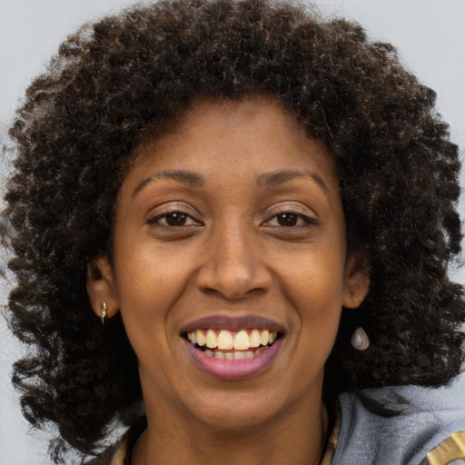 Joyful black young-adult female with medium  brown hair and brown eyes