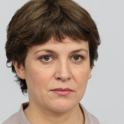 Joyful white adult female with medium  brown hair and grey eyes