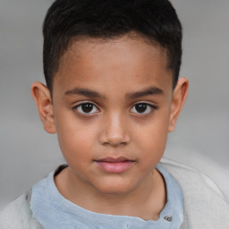 Joyful white child male with short  brown hair and brown eyes