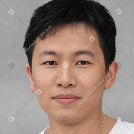 Joyful asian young-adult male with short  black hair and brown eyes