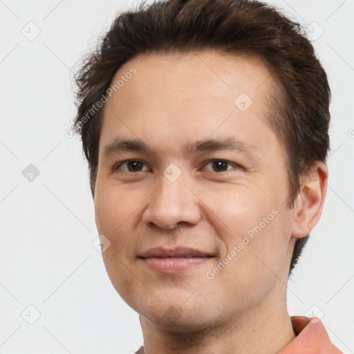 Joyful white adult male with short  brown hair and brown eyes