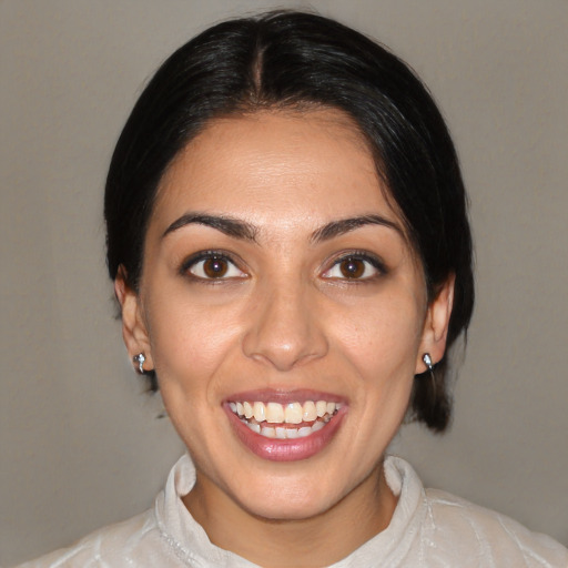 Joyful latino young-adult female with medium  black hair and brown eyes