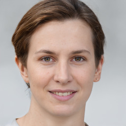 Joyful white young-adult female with short  brown hair and grey eyes