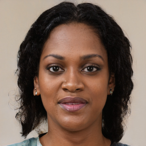 Joyful black young-adult female with medium  black hair and brown eyes