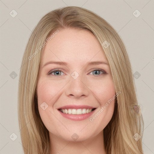 Joyful white young-adult female with long  blond hair and blue eyes